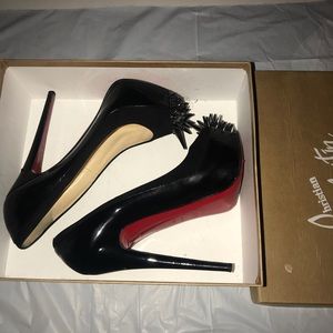 Black Christian Louboutin patent leather pumps